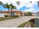 One-story single-Gathering home with well-manicured landscaping and circular paved driveway, enhancing its charming curb appeal and welcome feeling at 3235 Seaway Dr, New Port Richey, FL 34652