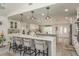 Bright and airy kitchen featuring a large island, seating, and seamless integration with the dining and living areas at 3235 Seaway Dr, New Port Richey, FL 34652