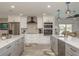 Modern kitchen with stainless steel appliances, a stylish range hood, and a large island with plenty of counter space at 3235 Seaway Dr, New Port Richey, FL 34652