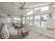 Bright sunroom featuring large windows with water views, casual seating, and wood-look flooring at 3235 Seaway Dr, New Port Richey, FL 34652
