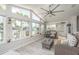 Inviting sunroom featuring water views, a ceiling fan, casual seating, and light-colored flooring at 3235 Seaway Dr, New Port Richey, FL 34652
