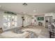 Inviting living room with a decorative rug, front door, and plantation shutters, creating a bright, welcoming ambiance at 3235 Seaway Dr, New Port Richey, FL 34652