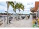 Inviting waterfront patio with palm trees, hammock, and outdoor seating perfect for relaxation at 3235 Seaway Dr, New Port Richey, FL 34652