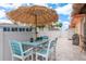 Charming patio area with a blue dining set, umbrella and a built-in grill at 3235 Seaway Dr, New Port Richey, FL 34652