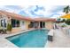 A private in-ground pool features a tiled water feature and travertine deck at 3235 Seaway Dr, New Port Richey, FL 34652