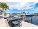 Picturesque waterfront patio with comfortable seating and boat dock featuring the 'Sandy Beach' boat at 3235 Seaway Dr, New Port Richey, FL 34652