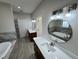 Modern bathroom featuring dual vanities with marble countertops and a soaking tub at 37565 Teri Ct, Dade City, FL 33525