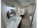 Bright bathroom with dual vanities, modern lighting, and luxurious soaking tub surrounded by marble tile at 37565 Teri Ct, Dade City, FL 33525