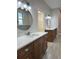 Bright bathroom with dual vanities, modern lighting, and luxurious walk-in closet at 37565 Teri Ct, Dade City, FL 33525