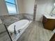 Bathtub features marble tile and sleek hardware at 37565 Teri Ct, Dade City, FL 33525