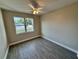 The bedroom offers wood-look floors and a view of the neighborhood at 37565 Teri Ct, Dade City, FL 33525