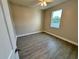 Bedroom with a view, wood-look floors, and neutral colored walls at 37565 Teri Ct, Dade City, FL 33525