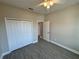 This bedroom features a closet and wood-look floors for a modern look at 37565 Teri Ct, Dade City, FL 33525