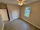 Bedroom with a closet, wood-look floors, and a view of the backyard at 37565 Teri Ct, Dade City, FL 33525