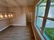Dining room showcasing the modern lighting, tile floors, and views from the large windows at 37565 Teri Ct, Dade City, FL 33525