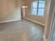 Well-lit dining room featuring a modern chandelier, large window, and tile flooring, ideal for Gathering meals at 37565 Teri Ct, Dade City, FL 33525