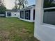 Screened in patio on the rear exterior of the home with green grass at 37565 Teri Ct, Dade City, FL 33525