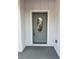 Stylish front door featuring decorative glass and enhanced security features, set in a clean, bright entrance at 37565 Teri Ct, Dade City, FL 33525