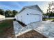 Detached garage with paved walkway and manicured landscape at 37565 Teri Ct, Dade City, FL 33525