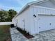 Detached garage with paved walkway and manicured landscape at 37565 Teri Ct, Dade City, FL 33525