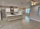 Open kitchen with white cabinets, center island, stainless steel appliances, stylish backsplash, and recessed lighting at 37565 Teri Ct, Dade City, FL 33525