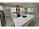 Bright kitchen featuring an island with a sink, stainless steel appliances, and decorative backsplash at 37565 Teri Ct, Dade City, FL 33525