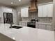 Stylish kitchen with white cabinets, granite countertops, stainless steel appliances, and a decorative tile backsplash at 37565 Teri Ct, Dade City, FL 33525