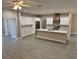 Bright open-concept kitchen featuring a center island, white cabinets, and modern appliances, perfect for entertaining at 37565 Teri Ct, Dade City, FL 33525
