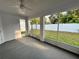 Enclosed lanai with a concrete floor and views of the spacious, fenced backyard at 37565 Teri Ct, Dade City, FL 33525