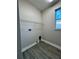 Spacious laundry room with tile floor, window and shelving unit and utility hookups at 37565 Teri Ct, Dade City, FL 33525