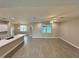 Bright, open-concept living room with wood-look floors, ceiling fan and an abundance of natural light at 37565 Teri Ct, Dade City, FL 33525