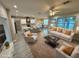 A spacious living room seamlessly flows into a modern kitchen with a large island and bar seating at 37565 Teri Ct, Dade City, FL 33525