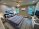 Staged main bedroom featuring a large bed, neutral color palette, and natural light at 37565 Teri Ct, Dade City, FL 33525