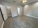 This spacious main bedroom features sleek flooring, neutral paint, and ensuite bathroom at 37565 Teri Ct, Dade City, FL 33525