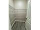 Walk-in closet with wood look tile floor and ample shelving space for storage at 37565 Teri Ct, Dade City, FL 33525