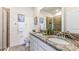 Bathroom featuring a dual sink vanity with granite countertop, white cabinetry, and a glass-enclosed shower at 4039 Westwood Fields Loop, Plant City, FL 33565