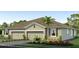Charming exterior featuring a two-car garage and beautiful landscaping at 4039 Westwood Fields Loop, Plant City, FL 33565