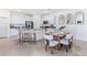 Open kitchen with white cabinets, a breakfast bar, and a dining area at 4039 Westwood Fields Loop, Plant City, FL 33565