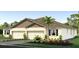 Beautful new home with a two-car garage, neutral color palette, lush landscaping and a well-manicured lawn at 4045 Westwood Fields Loop, Plant City, FL 33565