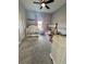 Cozy bedroom featuring a crib, play furniture, carpet flooring and modern ceiling fan at 4294 Cork Rd, Plant City, FL 33565