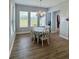 Bright dining room with large windows offering scenic views and a decorative chandelier at 4294 Cork Rd, Plant City, FL 33565