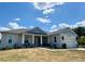 Charming one-story home with blue and gray exterior paint and well-manicured lawn at 4294 Cork Rd, Plant City, FL 33565