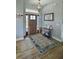 Inviting foyer with a decorative rug, a rustic table, and a beautiful front door at 4294 Cork Rd, Plant City, FL 33565