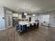 Spacious kitchen featuring a large island, stainless steel appliances, and modern lighting fixtures at 4294 Cork Rd, Plant City, FL 33565