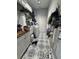 Well-organized laundry room with patterned floors, storage shelves, and a utility sink with a wood countertop at 4294 Cork Rd, Plant City, FL 33565