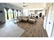 Open-concept living room featuring hardwood floors and seamless flow to kitchen and dining area at 4294 Cork Rd, Plant City, FL 33565