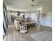 Open-concept living room featuring hardwood floors and seamless flow to kitchen and dining area at 4294 Cork Rd, Plant City, FL 33565