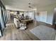 Open-concept living room featuring hardwood floors and seamless flow to kitchen and dining area at 4294 Cork Rd, Plant City, FL 33565