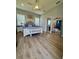 Spacious main bedroom with neutral colors, hardwood-style floors, and an ensuite bathroom at 4294 Cork Rd, Plant City, FL 33565