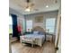 Bright main bedroom with a king bed, decorative details and hardwood-style floors at 4294 Cork Rd, Plant City, FL 33565